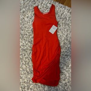 Athleta dress. Fitted. Cinched on sides from waist down. Tulip hemline. New.